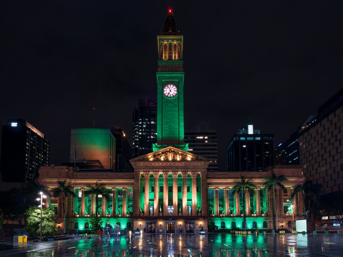 Brisbane City Hall at night, illuminated in green