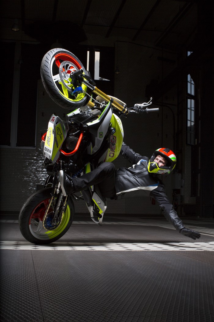 Motorcyclist performing a stunt on a BMW G 310 motorcycle