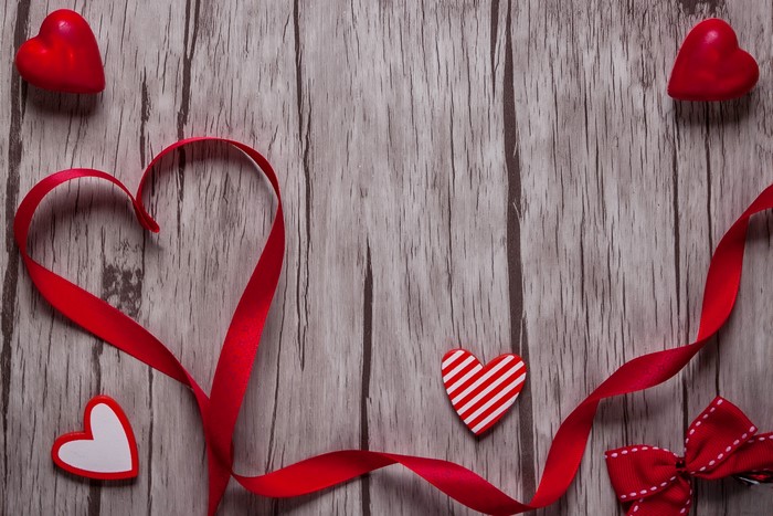 Valentine's Day Red Ribbon and Hearts on Wood