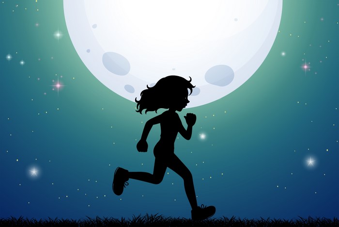 Silhouette of a girl running under the moon