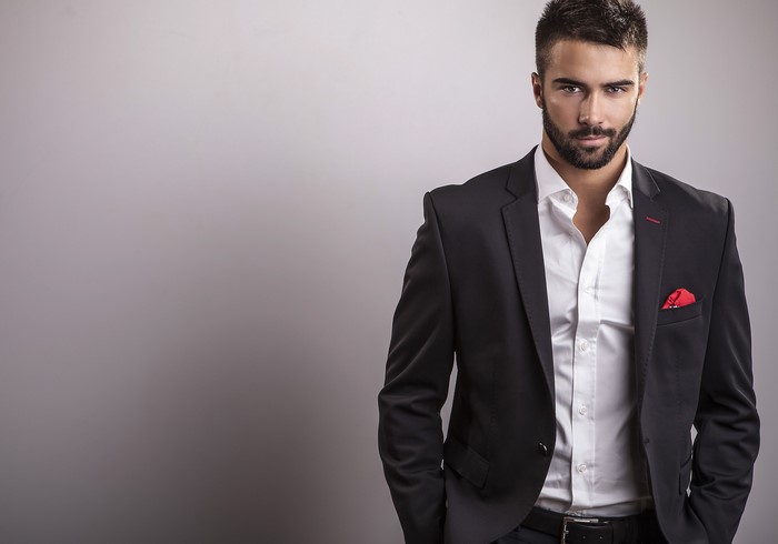 Man in a suit with a beard and red pocket square