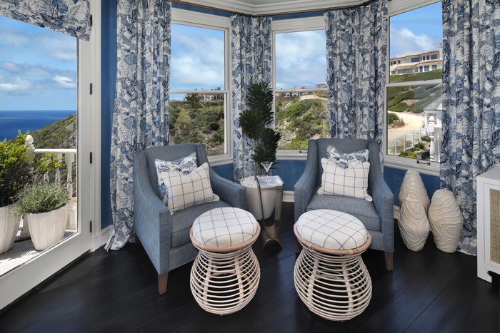 Living room with armchairs and ocean view