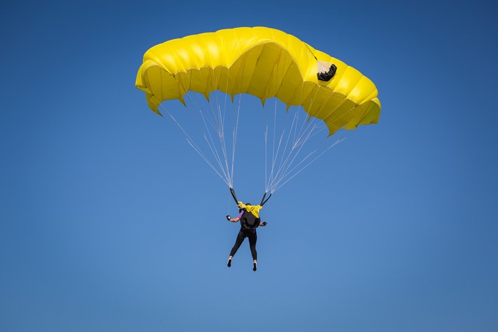Parachuting skydiving with yellow parachute