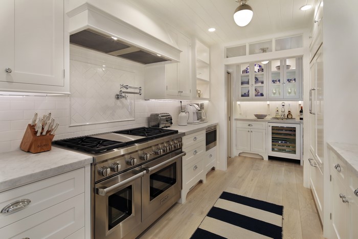 Modern white kitchen with stainless steel appliances