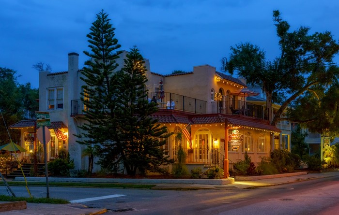 Building with Spanish Tile Roof and Trees at Dusk