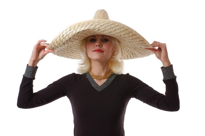 Woman in large straw hat and gold necklace
