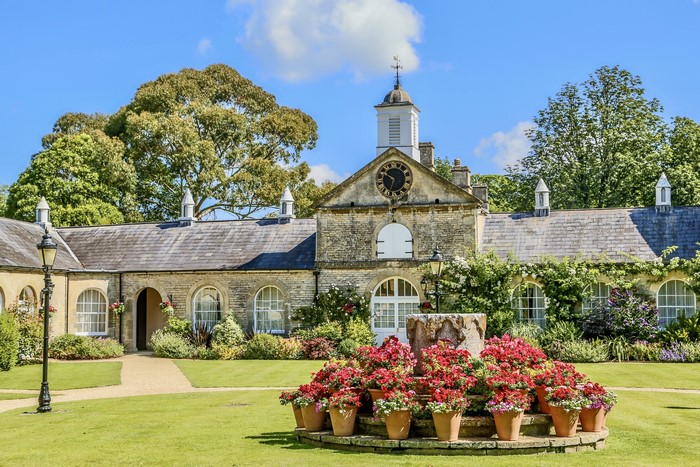 Country house with clock tower and flower garden
