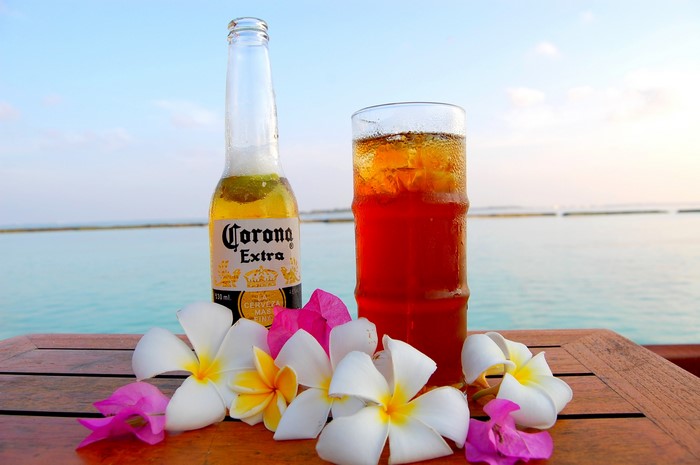 Corona Extra beer bottle and drink with flowers