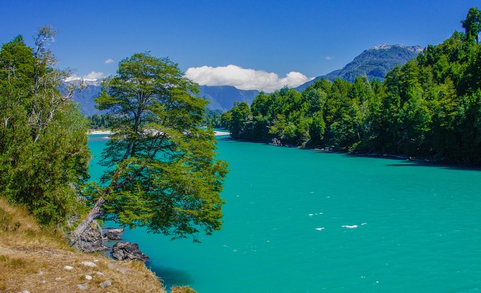 Turquoise River flowing through Patagonia, Chile with Mountains