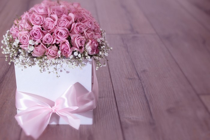Pink roses in a white box with a pink bow