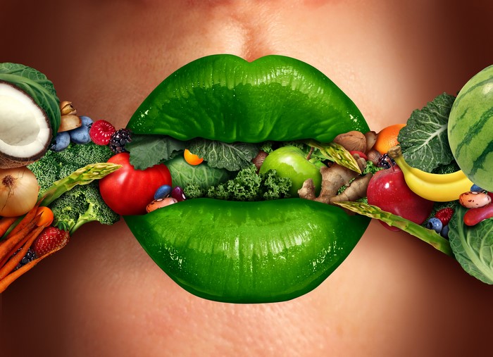 Green lips filled with fresh fruits and vegetables
