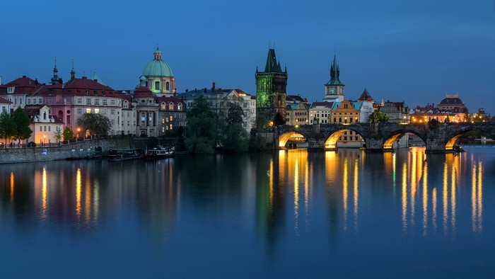 Charles Bridge and Prague skyline at dusk