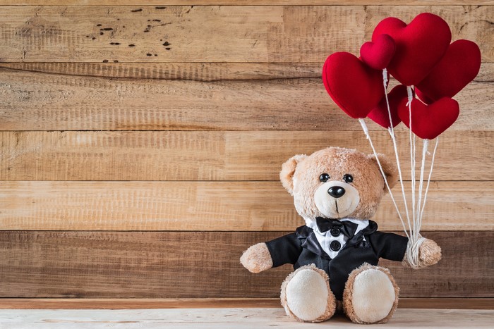 Teddy bear with red heart balloons