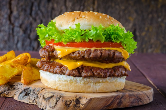 Double Cheeseburger with Fries on Cutting Board