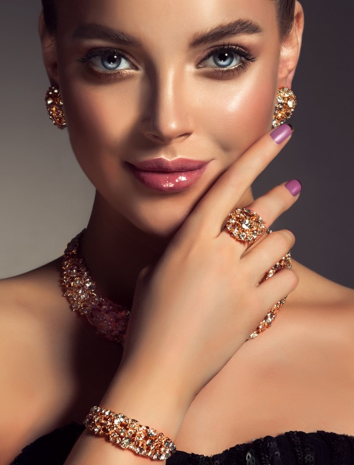 Woman wearing elaborate gold and diamond jewelry