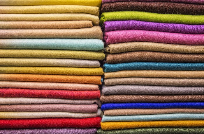Stacks of colorful folded fabrics