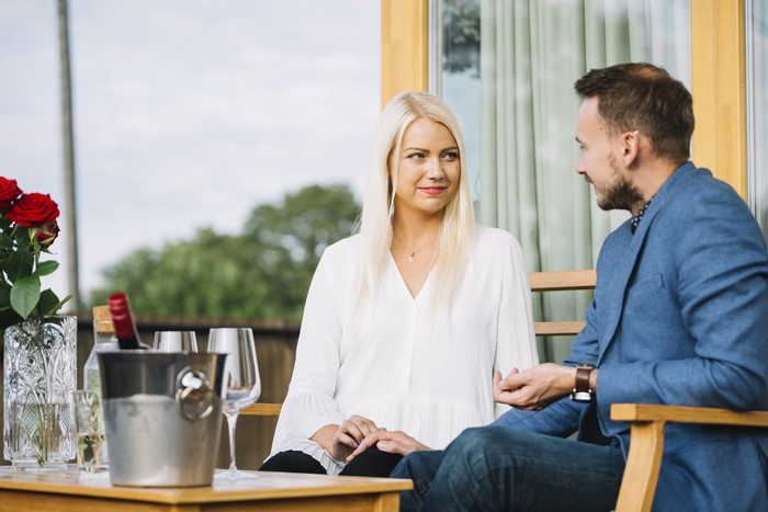 Couple sitting on a patio with wine