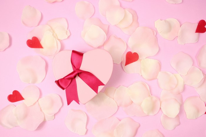 Heart-shaped gift box with petals and hearts