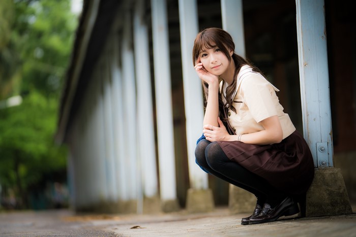 4K Cute Brown-Haired Girl Sitting with Bokeh Background