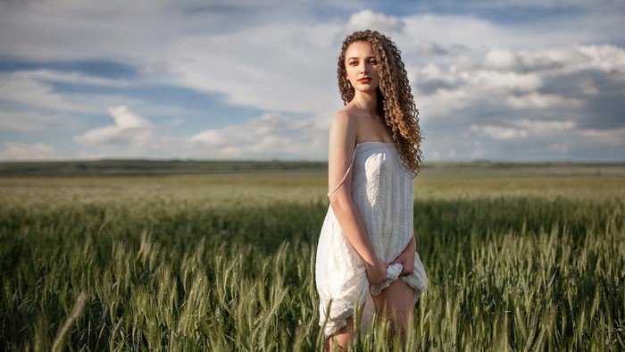 Aleksandra in a white dress in a field