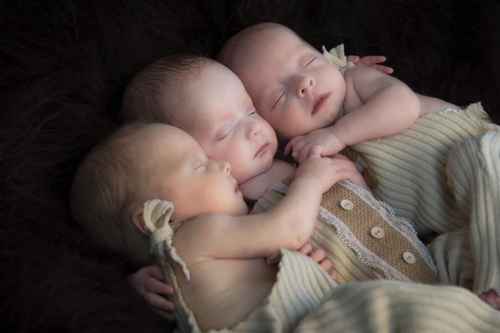 Three Newborn Babies Sleeping Together