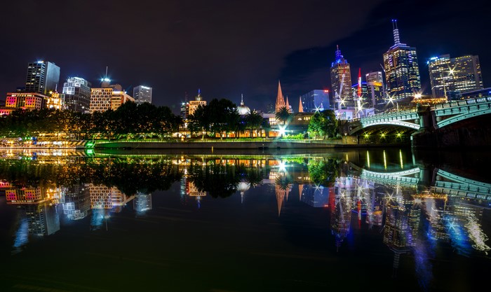 Melbourne skyline at night with river reflection