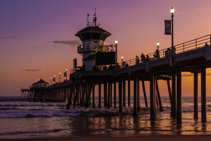 Huntington Beach Pier at sunset with waves