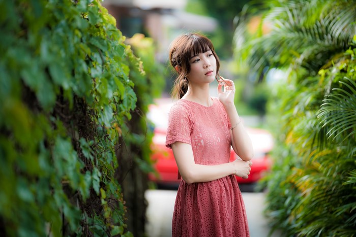 Asian woman in pink dress with brown hair