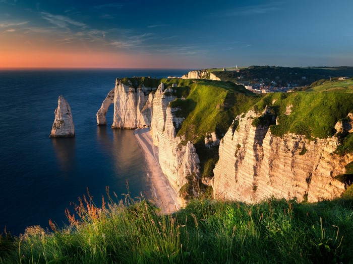 White cliffs and arch on the coast of France at sunset
