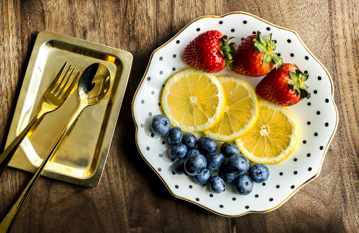 Strawberries, Lemons, Blueberries on a Plate with Utensils