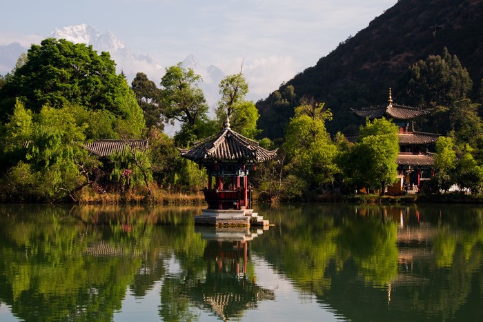 Pagoda on a lake in Lijiang, China with mountains