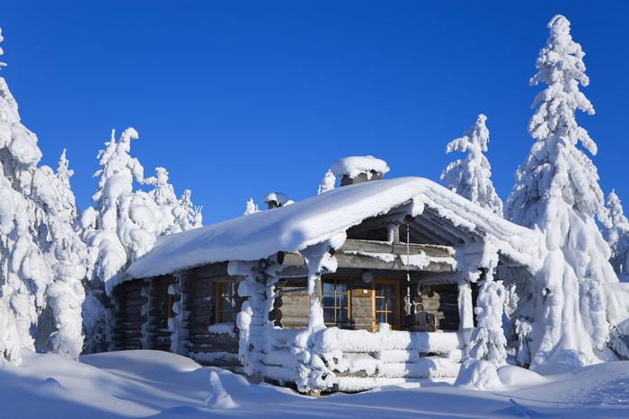 Wooden cabin in snowy Lapland, Finland