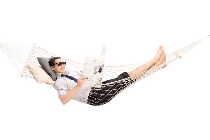 Man in Hammock Reading Newspaper