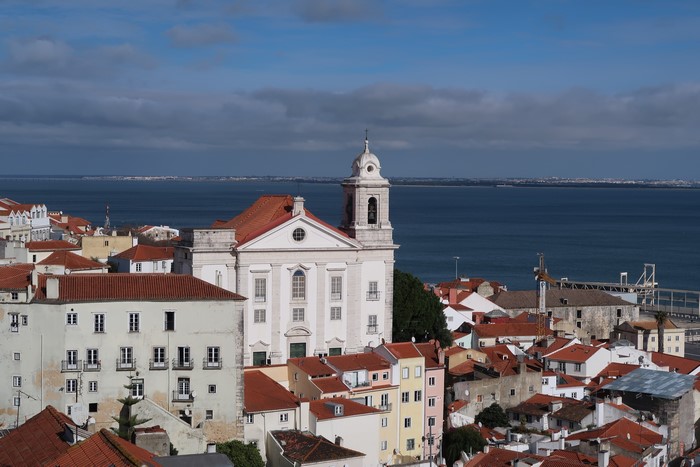 Church and houses overlooking the Tagus River in Lisbon, Portugal