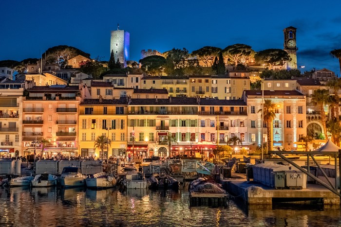 Cannes waterfront buildings and boats at dusk
