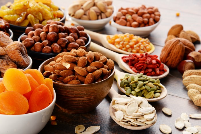 Assortment of Nuts and Dried Fruits in Bowls and Spoons