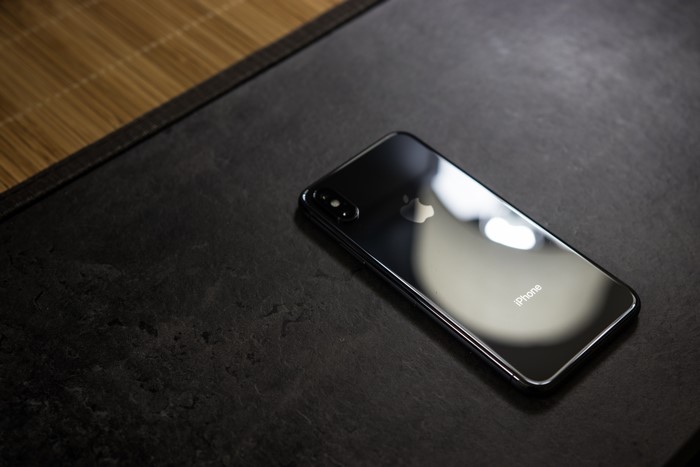 iPhone X on a dark surface