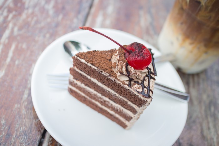 Chocolate cake with cherry and iced coffee