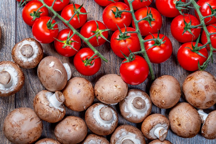 Tomatoes and Mushrooms on a Wooden Surface