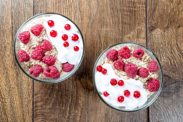 Muesli with raspberries and currants in bowls