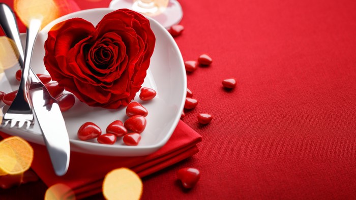 Valentine's Day table setting with rose and heart candies