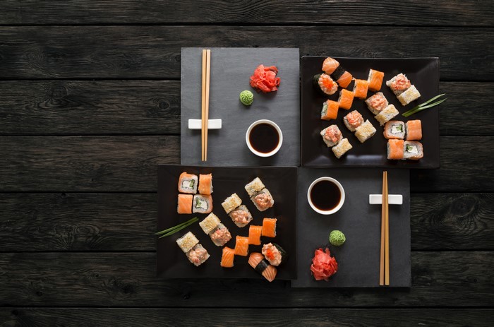 Sushi and Chopsticks on Dark Wood Planks