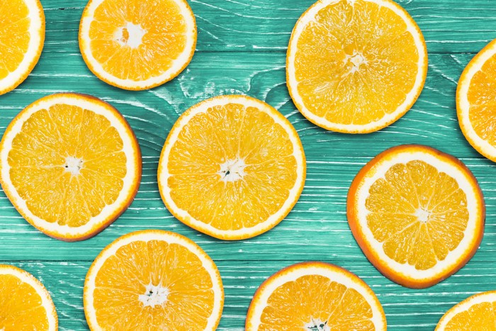 Orange fruit slices on teal wood planks