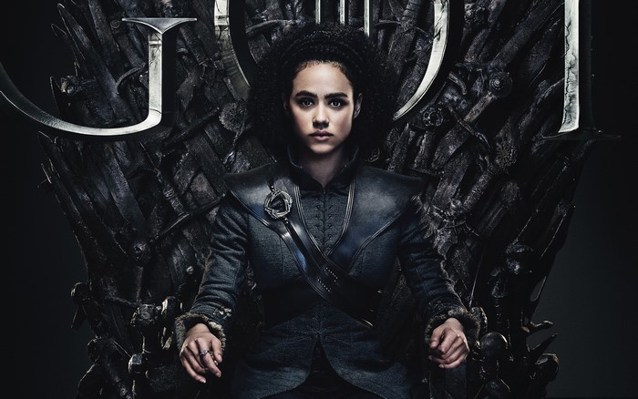 Missandei from Game of Thrones sitting on the Iron Throne
