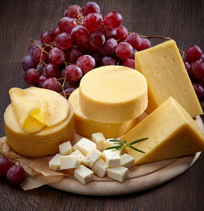 Cheese and Grapes on a Cutting Board