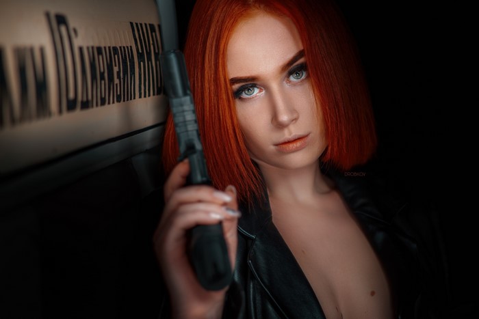 Redhead woman with pistol