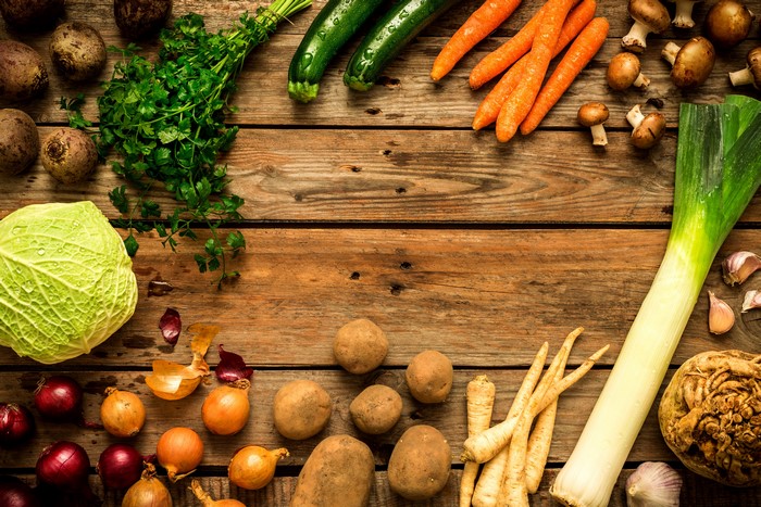 Assortment of fresh vegetables on wooden planks