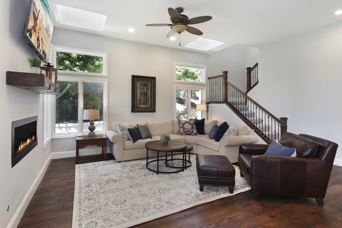 Living room with sofa, armchair, and fireplace