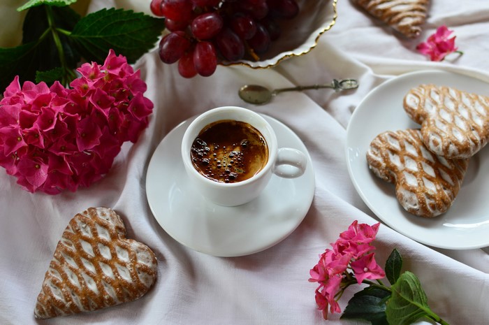 Coffee cup with heart cookies and hydrangea
