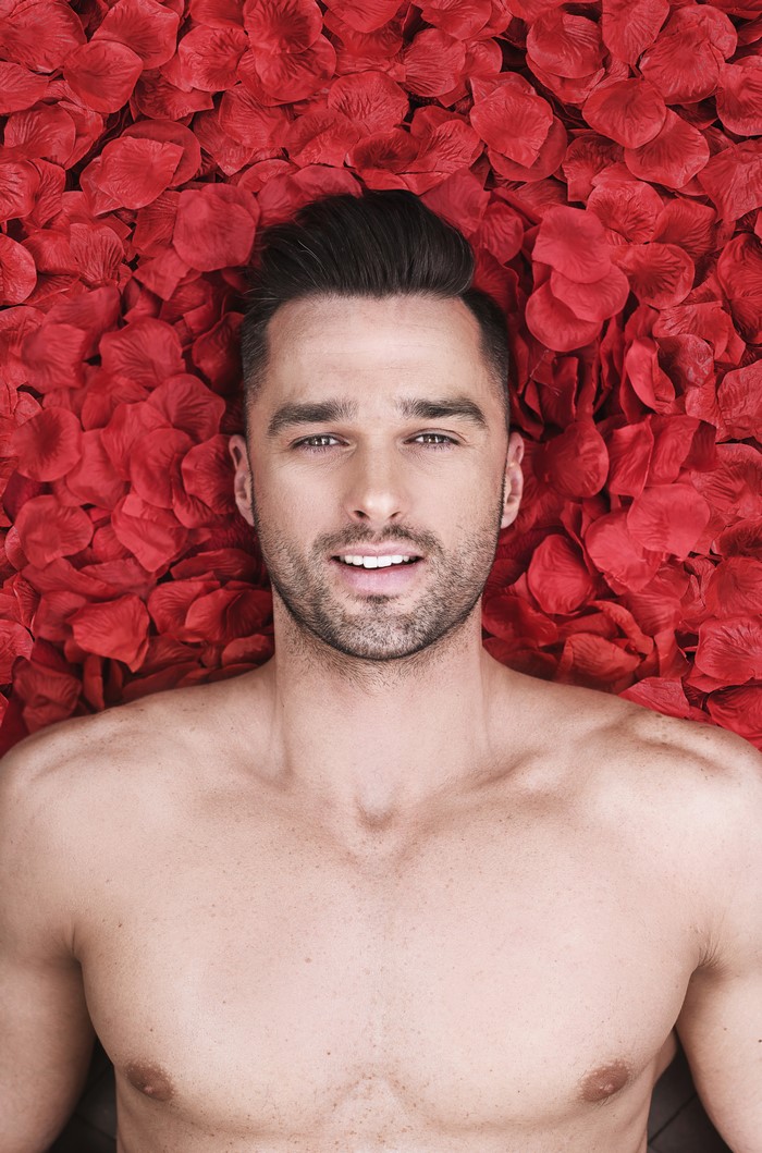 Man lying on red petals